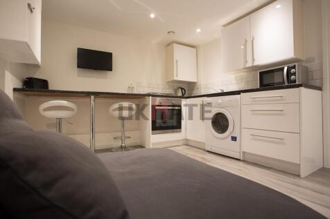 Modern, well-maintained kitchen with white cabi...