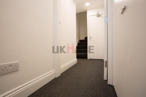 Bright, well-maintained hallway with neutral de...