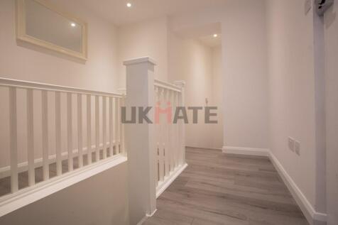 Bright, freshly painted hallway with modern woo...