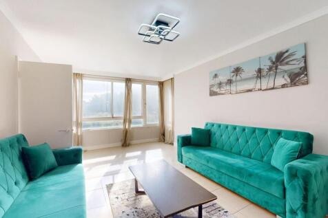 Bright and spacious living room featuring large...