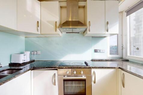 Bright and modern kitchen featuring a window wi...