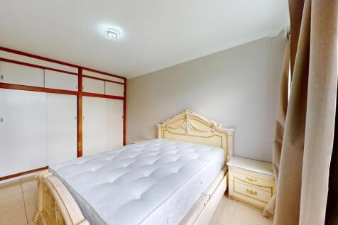 A spacious master bedroom featuring a large, or...