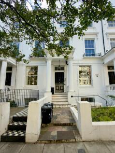 A charming white-fronted building with elegant ...