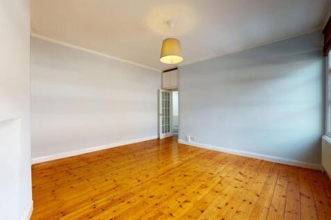 A bright and spacious living room featuring pol...