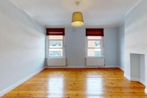 Bright and clean living room featuring polished...
