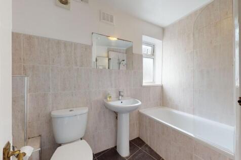 Bright and well-maintained bathroom featuring a...