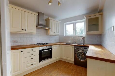 Bright and clean kitchen featuring wooden count...