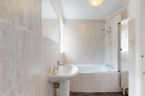 Bright and clean bathroom suite featuring a bat...