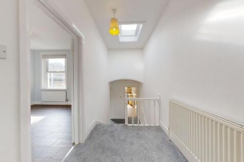 A bright and clean upstairs hallway featuring w...