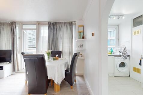 Bright and spacious living room featuring large...