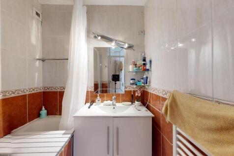 Clean and functional bathroom with a bathtub, m...