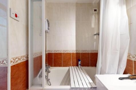 A modern bathroom featuring a bathtub with an o...