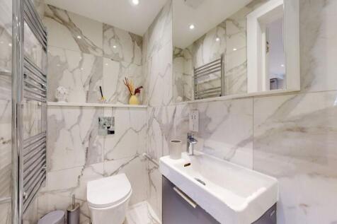 A sleek and modern single toilet room featuring...