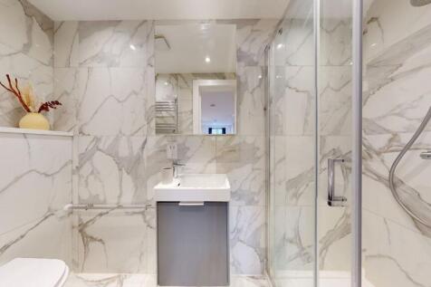 A modern bathroom clad in elegant marble-effect...