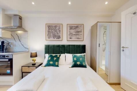 Bright and modern double bedroom featuring a co...