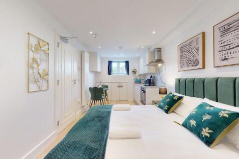 A bright and modern master bedroom featuring a ...