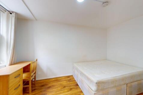 A clean and bright bedroom with a large window ...