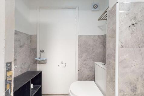 Bright and functional bathroom featuring a toil...