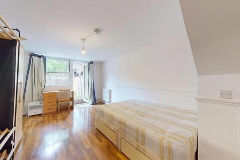 A bright and tidy bedroom featuring a double be...