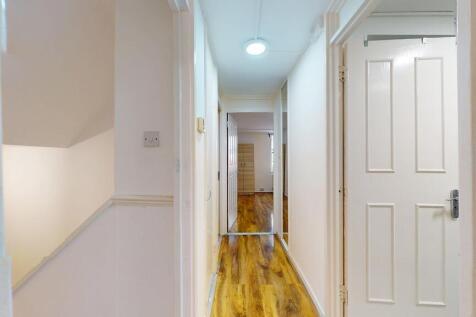 Bright, well-maintained hallway with wood-effec...