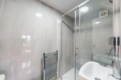Modern bathroom with a glass shower enclosure a...