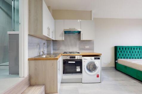 Modern kitchen with a compact layout featuring ...