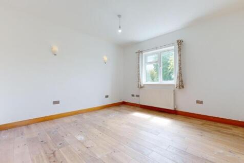 Bright and welcoming bedroom with a large windo...