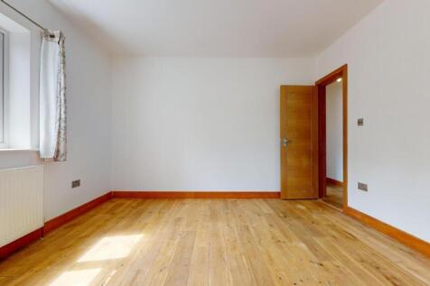 Bright and airy bedroom with a large window let...