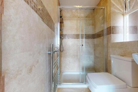 Bright and clean bathroom featuring a walk-in s...
