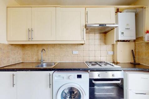 A well-organized kitchen featuring cream cabine...