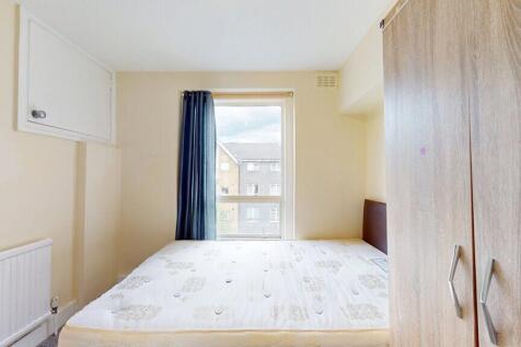 Bright double bedroom featuring a large window ...