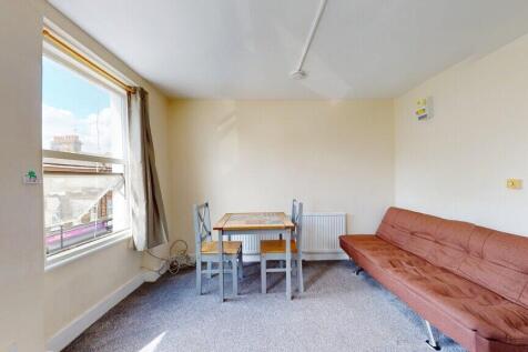 A bright living room featuring a large window w...