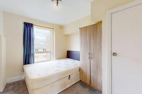 A cozy single bedroom featuring a comfortable s...