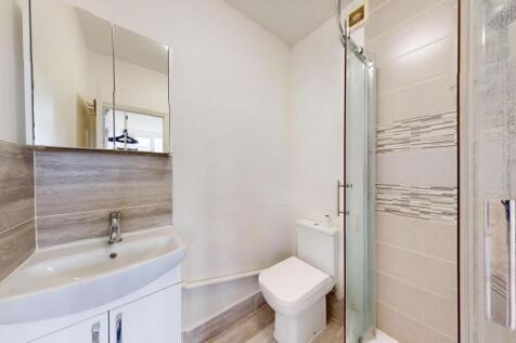 A clean and modern bathroom featuring a compact...