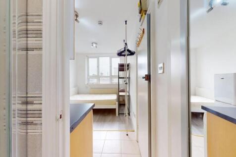 Bright and tidy bedroom with a large window pro...