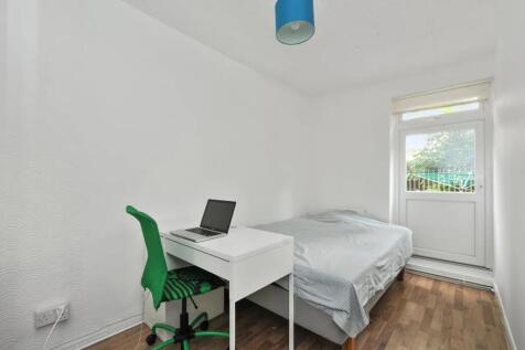 A clean and simple double bedroom featuring a w...