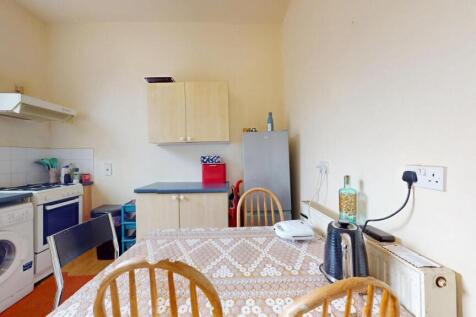 A bright and tidy kitchen featuring a washing m...