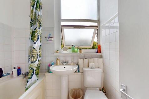 Bright and clean bathroom featuring a full-size...