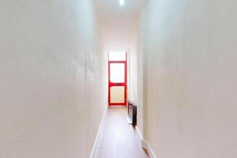 Bright and clean hallway featuring a red-framed...