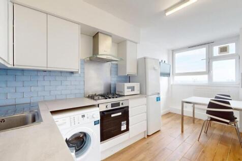 Bright modern kitchen with white cabinets, blue...