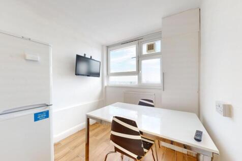 Bright compact kitchen/dining area with a large...