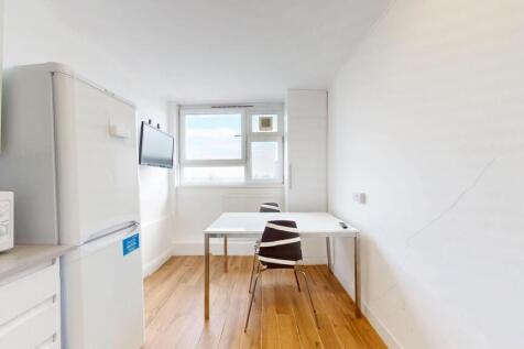 Bright, modern kitchen area with wooden floors,...