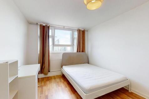 Bright, simply furnished bedroom with a double-...