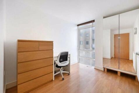 Bright and tidy small room featuring a large wi...