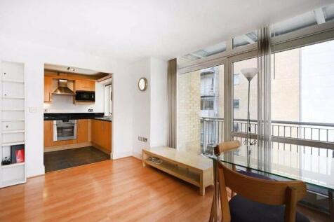 Bright and modern living room featuring large f...