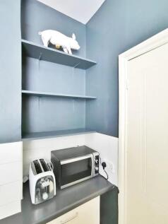 Compact kitchen corner featuring modern applian...
