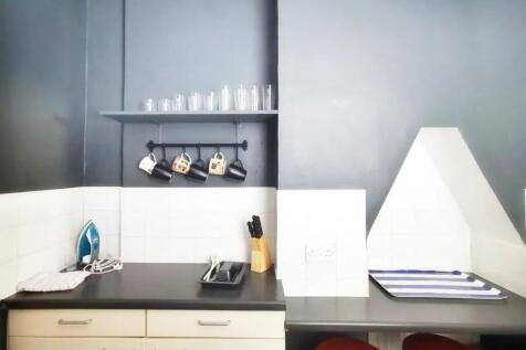 A neat and functional kitchen area featuring da...