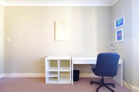 A bright and tidy communal workspace featuring ...