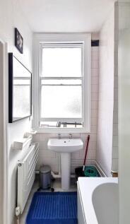 Bright and clean bathroom featuring a classic w...