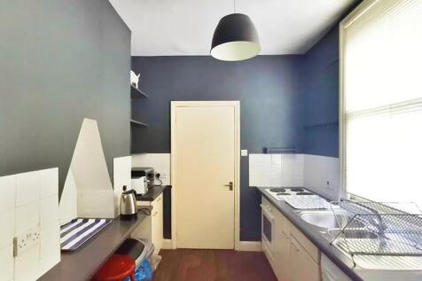 A compact and tidy kitchen featuring modern app...